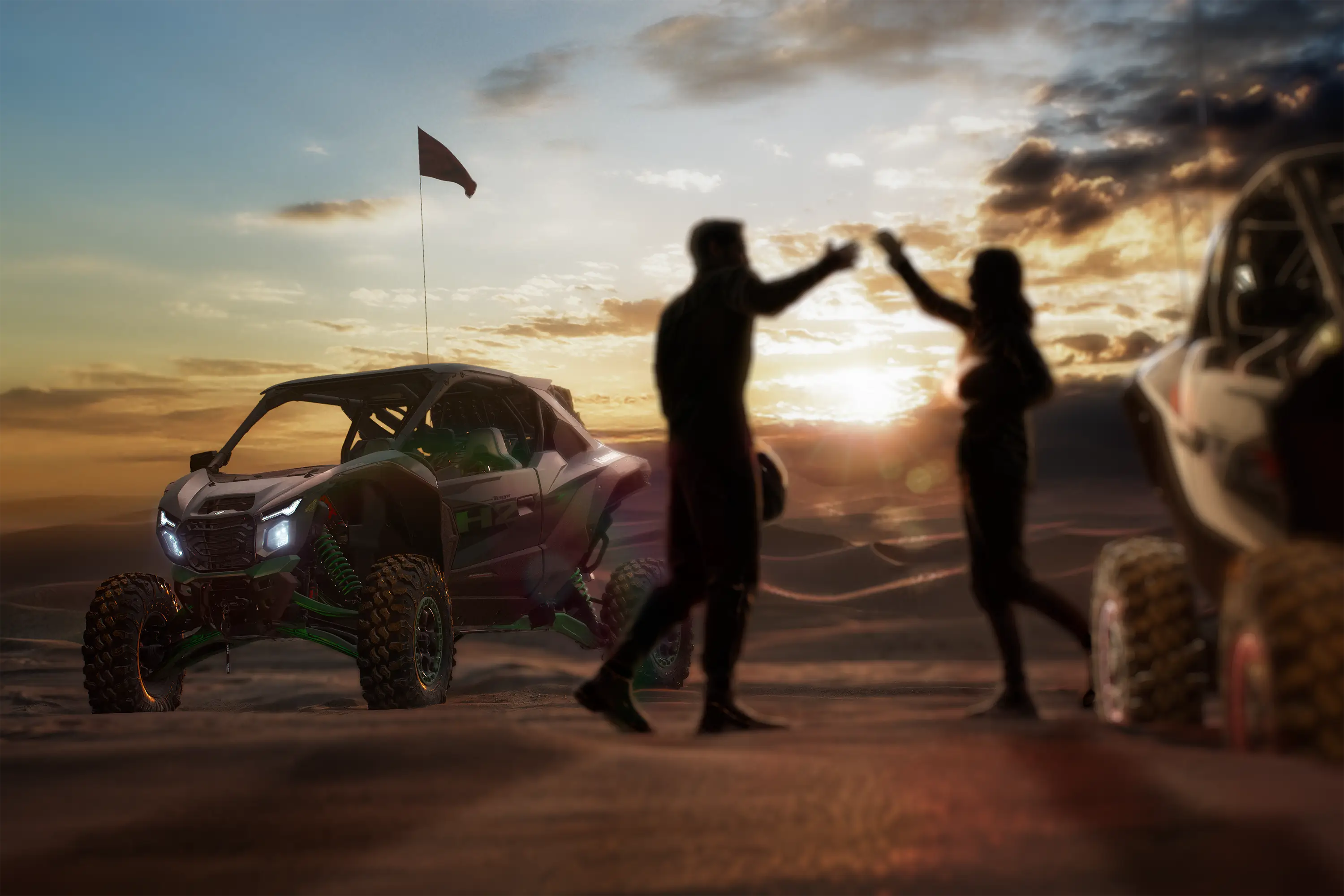 Three-quarter rear angle of two people and a side x side parked on sand.