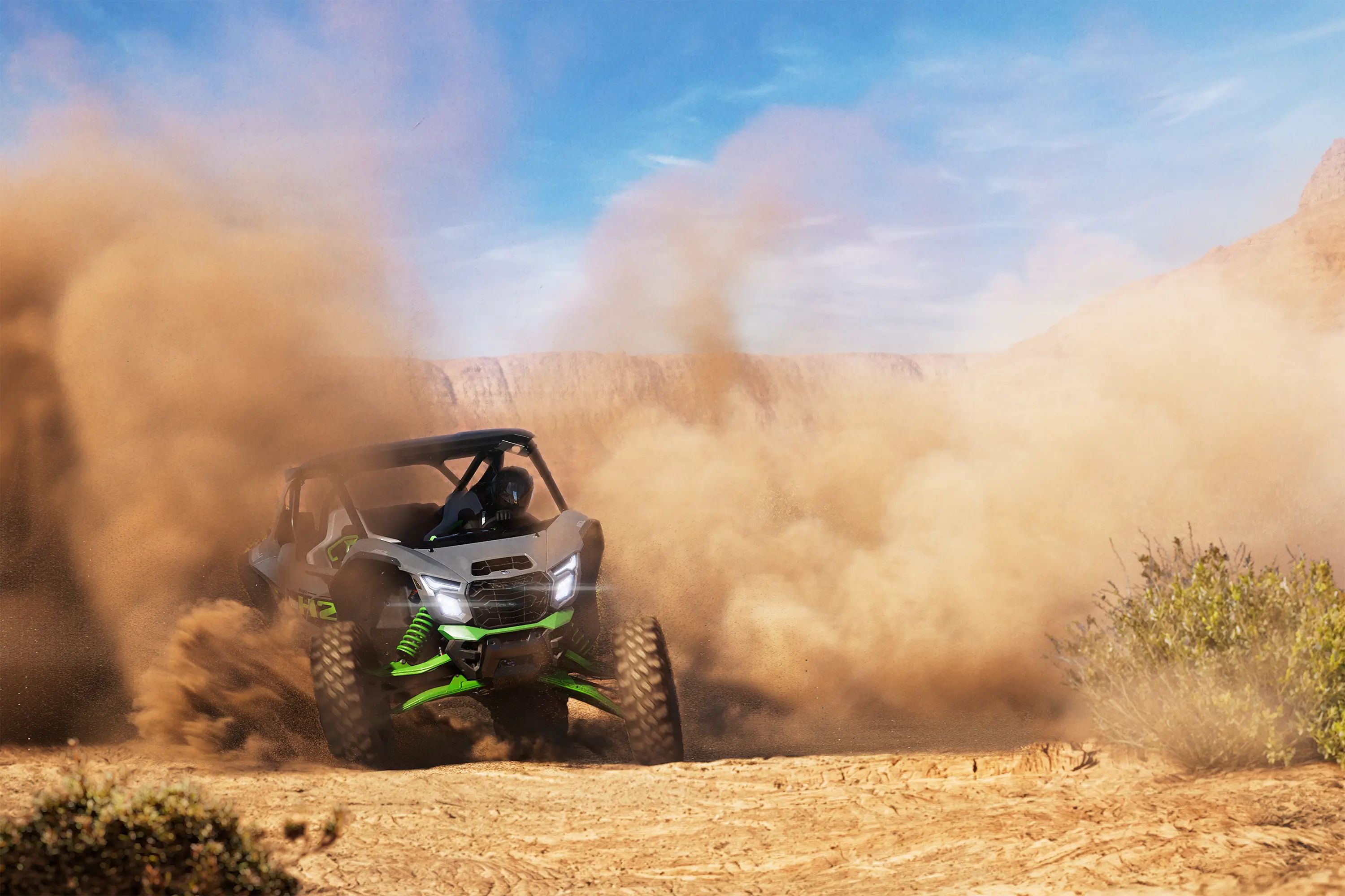 Three-quarter front angle of a person sliding a side x side off-road in the distance.