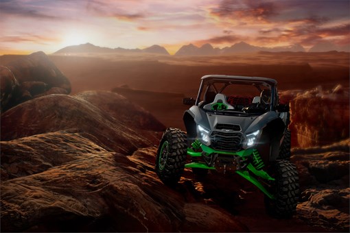 Three-quarter rear angle of a side x side parked on sand. opens in a new window