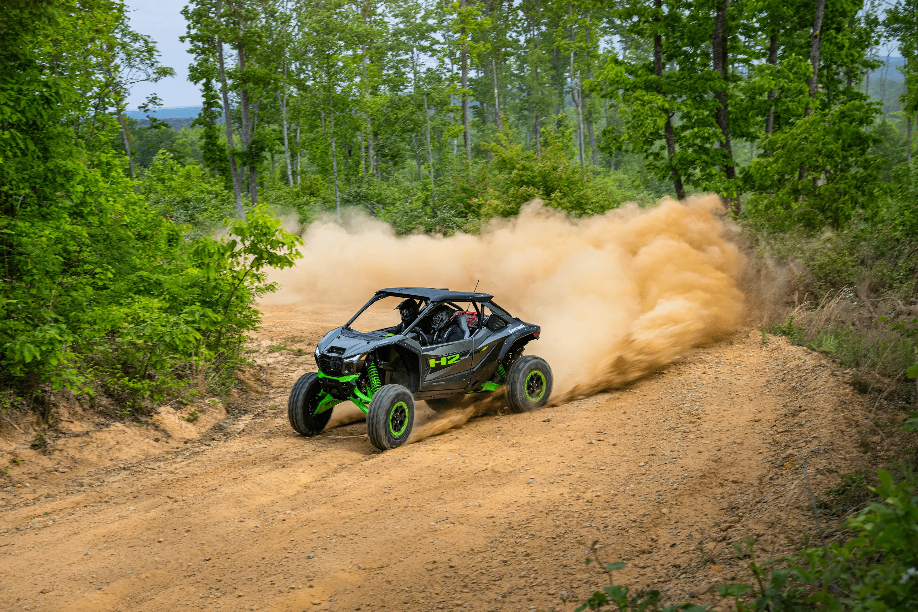 Side x side sliding around corner off-road.