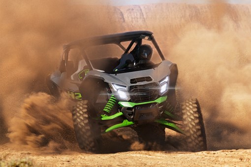 Three-quarter front angle of a person sliding a side x side off-road. opens in a new window