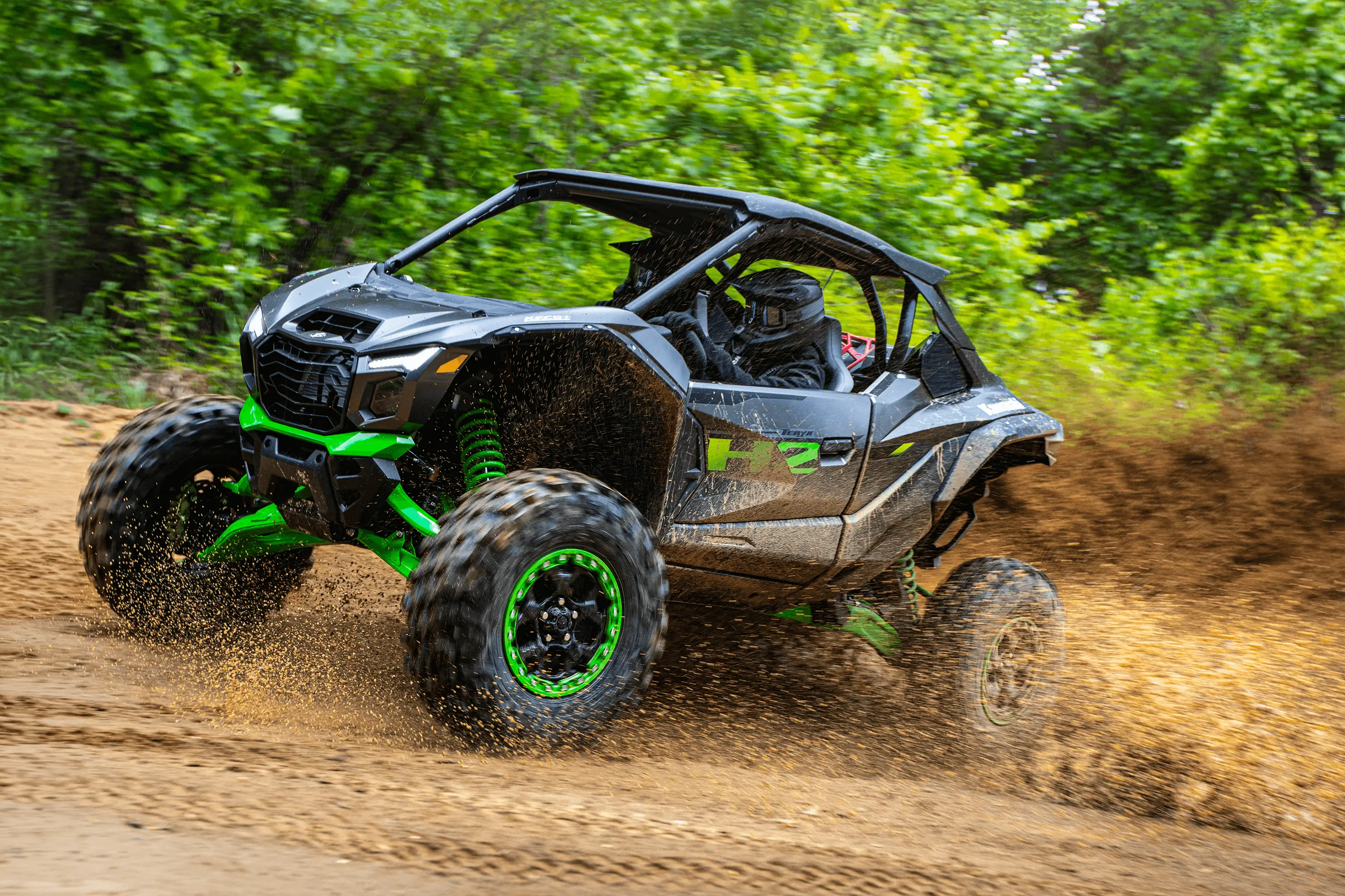 Side angle of a person driving a side x side uphill off-road.