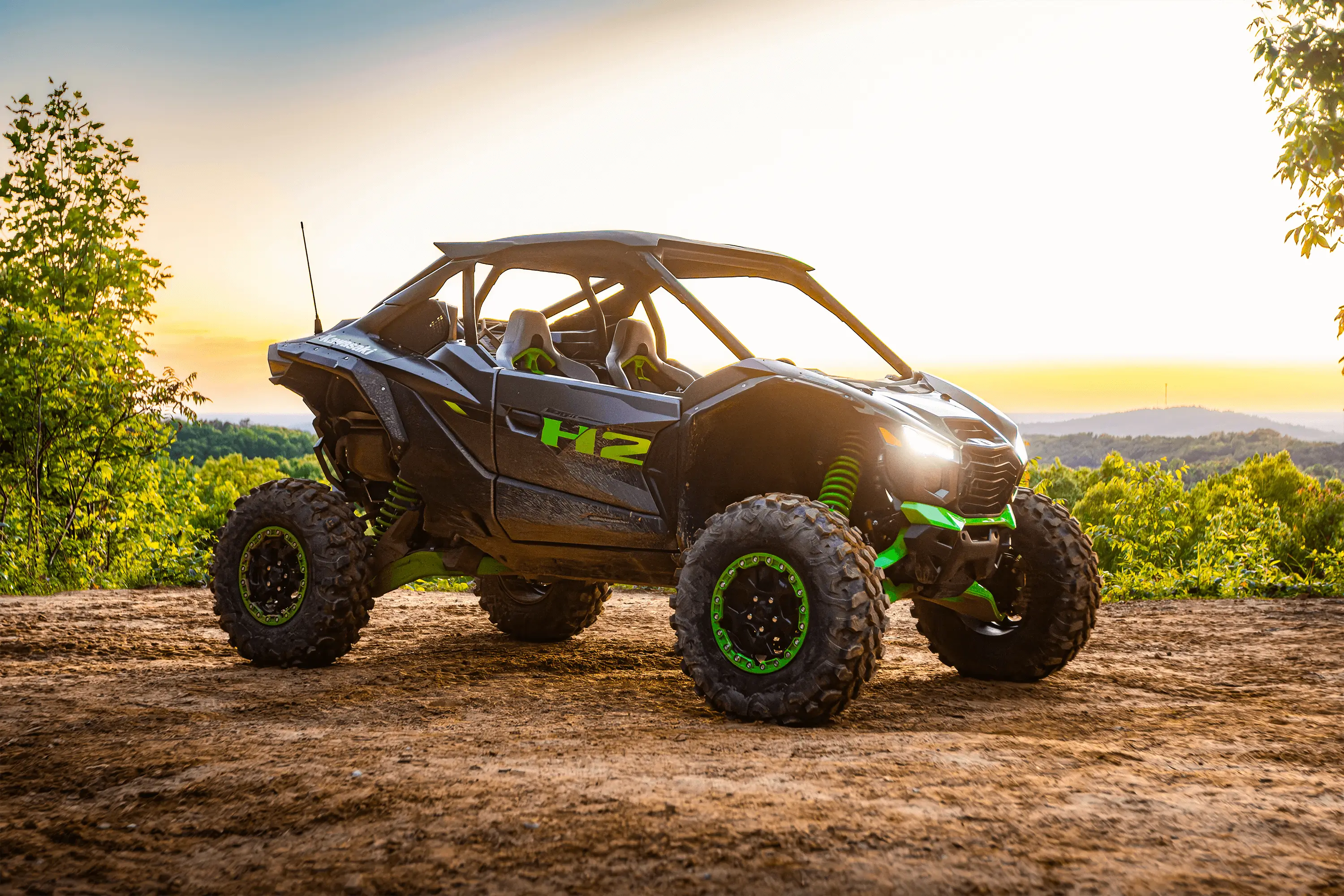 Side x side parked off-road at sunset.