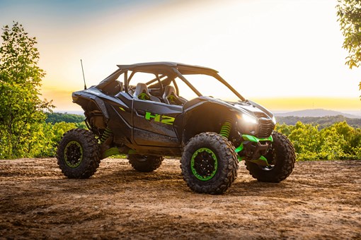 Side x side parked off-road at sunset. opens in a new window