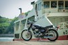 Profile angle of a motorcycle staged in front of a dock.