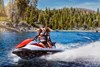 Profile angle of people riding a personal watercraft on water.