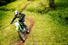 Top angle of person riding a motorcycle on a dirt trail.
