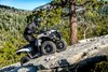 Three-quarter front angle of person riding an ATV over a rocky trail.
